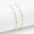 Two gold and silver beaded necklaces on a white stone surface.