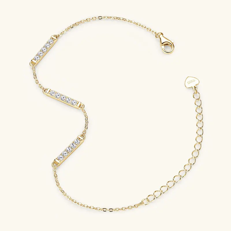 Gold bracelet with clear stones on a white background