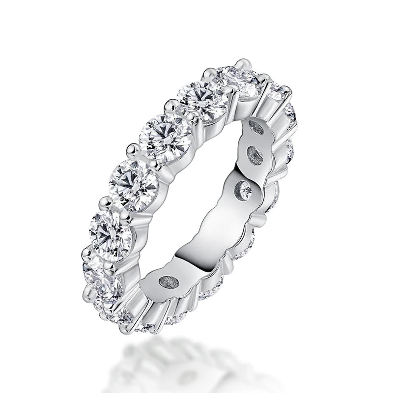 Silver ring with clear gemstones on a white background