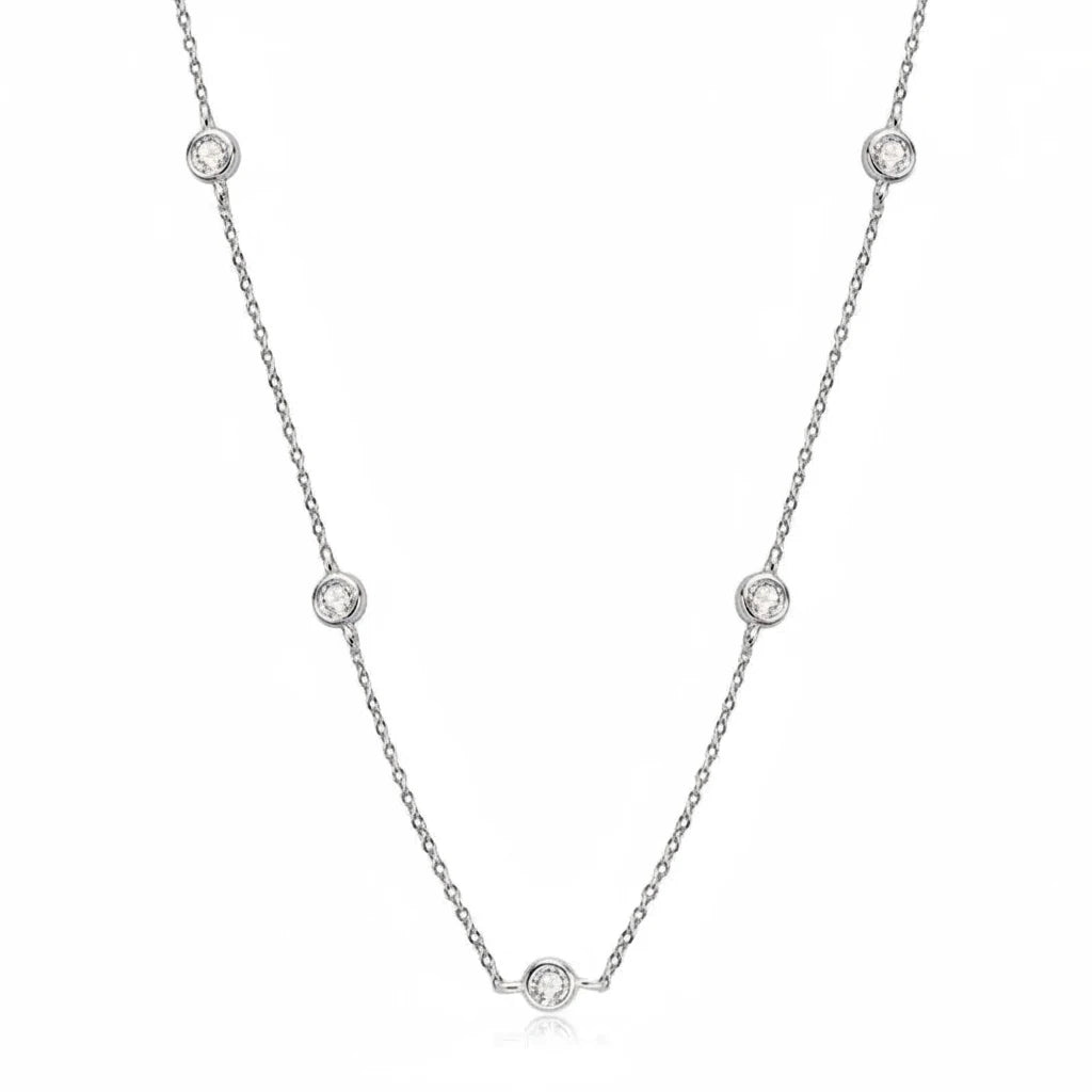A delicate silver chain necklace with five small round bezel-set clear stones spaced along the chain, shown on a white background with the Chasau brand logo in the upper left.