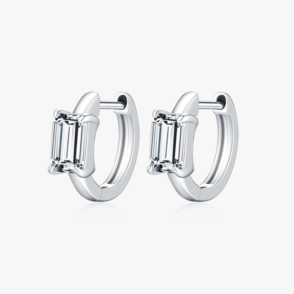 Pair of silver hoop earrings with baguette-cut gemstones on a white background