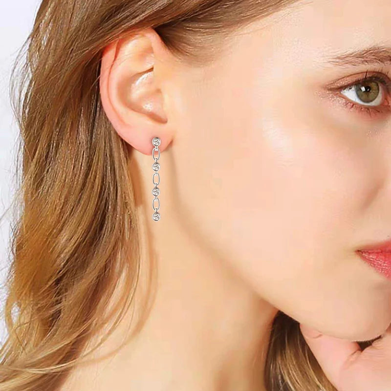 Close-up of a woman wearing a silver hoop earring with a blurred background