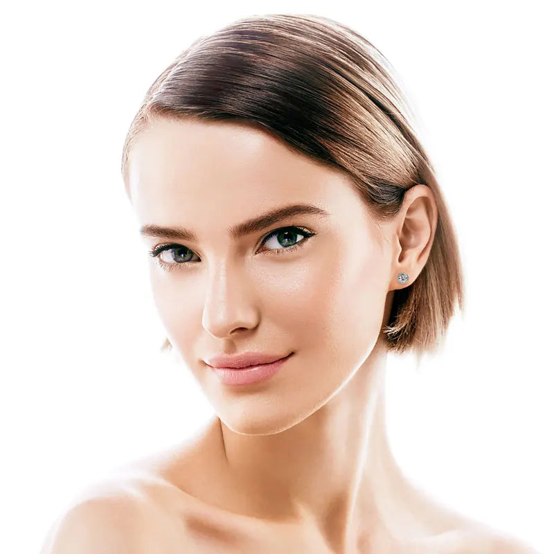 Close-up of a woman with a smooth neck and shoulders on a white background