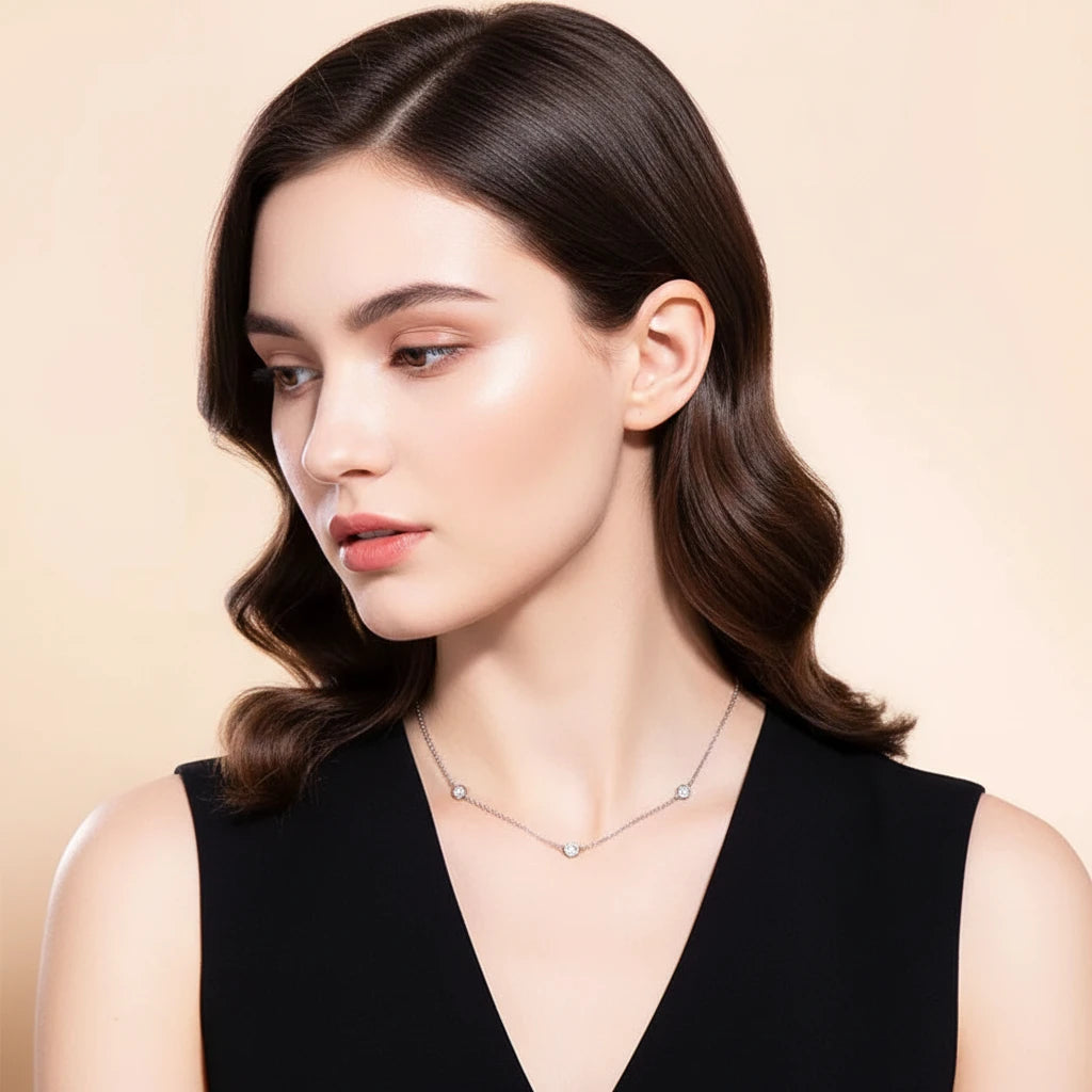 Woman wearing a gold necklace against a beige background