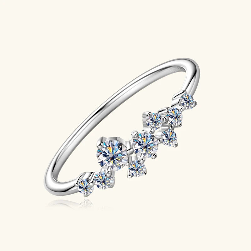 Silver ring with heart-shaped gemstones on a white background