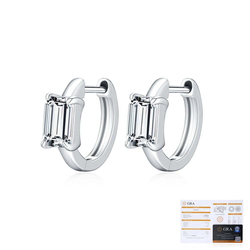 Pair of silver hoop earrings with baguette-cut gemstones and a GRA certificate on a white background.