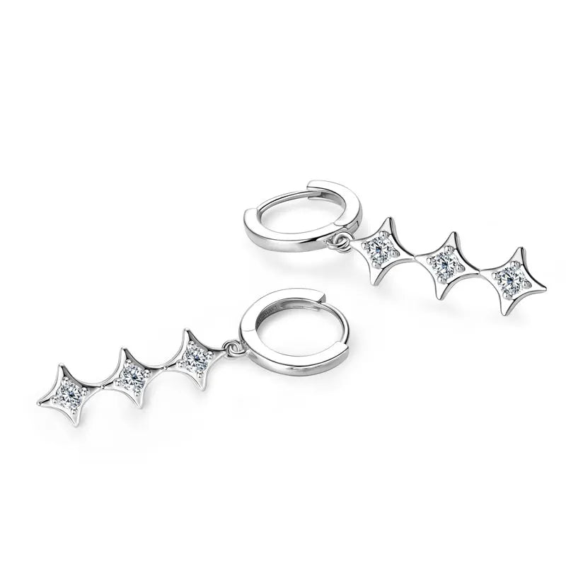 A pair of silver hoop earrings with three bat-wing shaped charms set with clear stones, displayed on a clean white background.