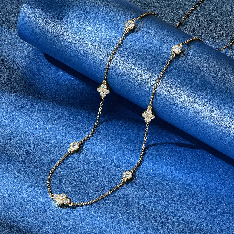 Gold necklace with floral pendants on a blue satin background