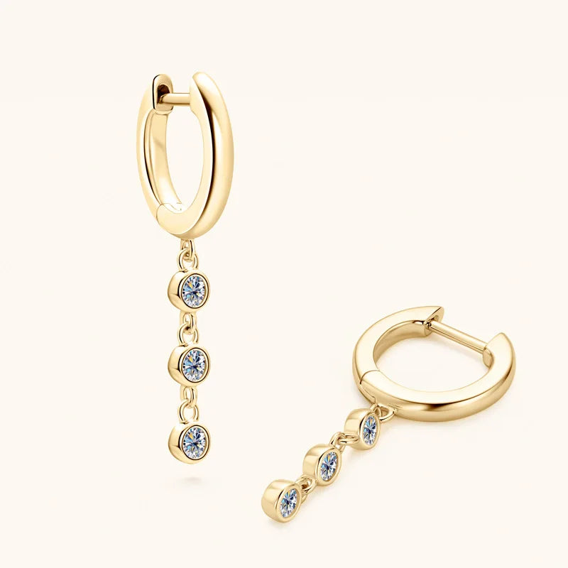Gold hoop earrings with small gemstones on a white background