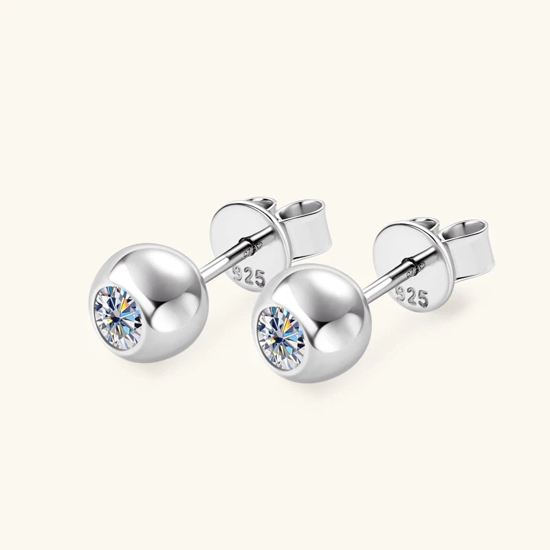 Silver stud earrings with clear gemstones on a white background