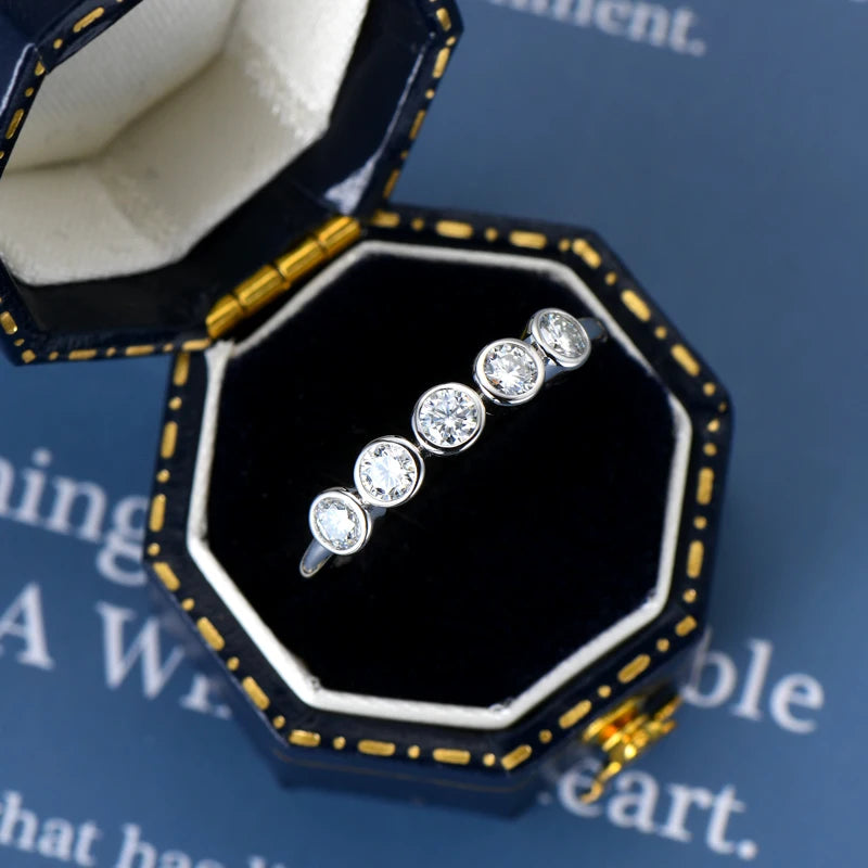 Diamond ring in an open jewelry box on a blue background