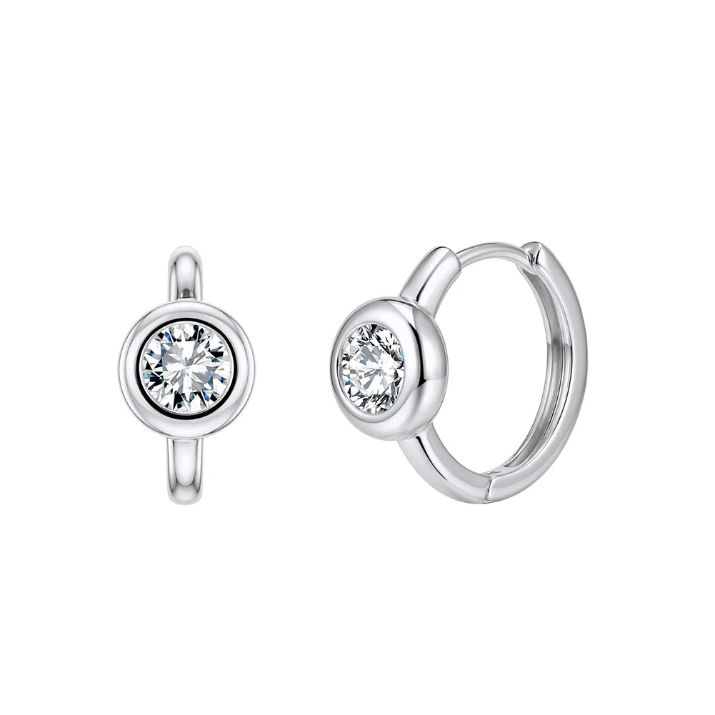 A pair of silver hoop earrings with a single round clear gemstone in a bezel setting, shown from two angles on a plain white background.