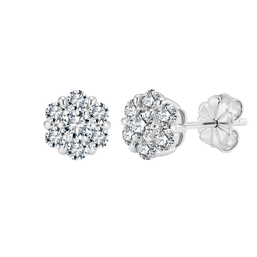 A pair of silver stud earrings with round cluster diamond settings, showing both the front face of one earring and the side profile with butterfly back on a white background.