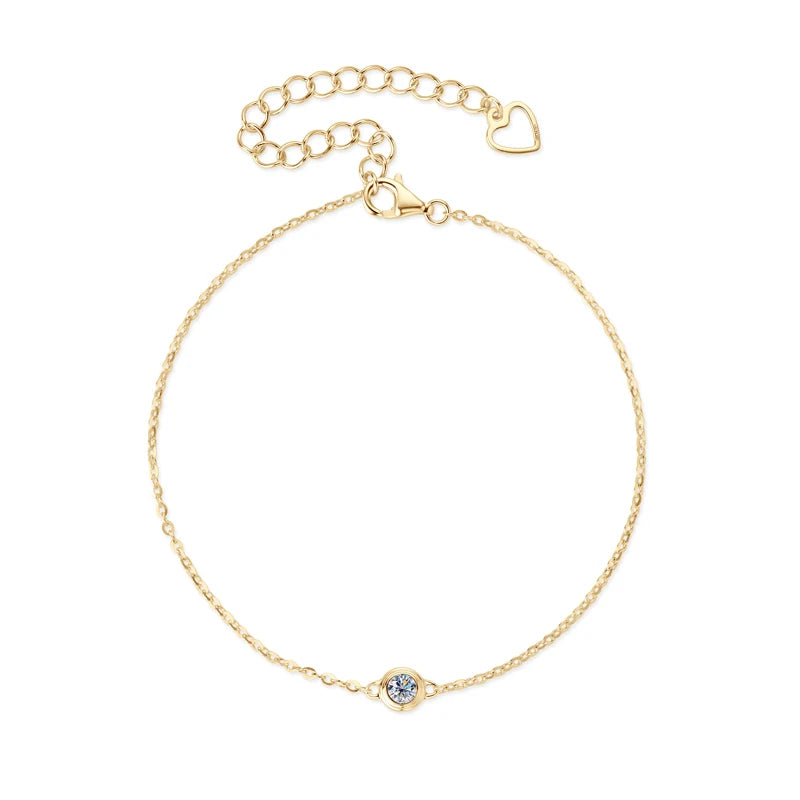 Gold bracelet with a small round clasp on a white background