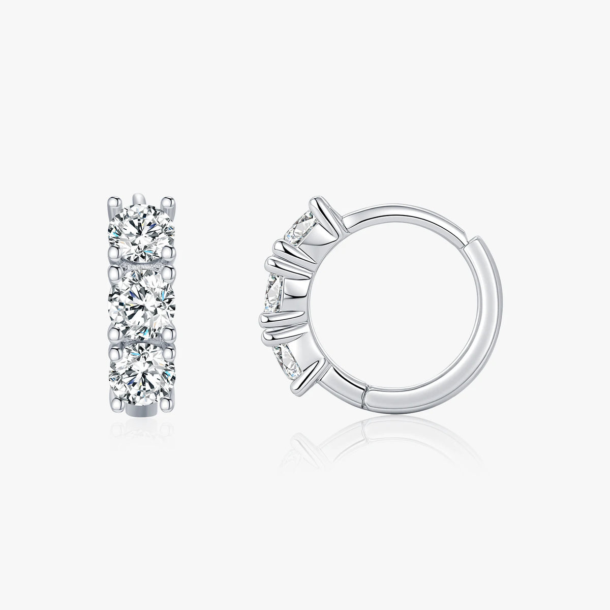 Pair of silver hoop earrings with clear gemstones on a white background