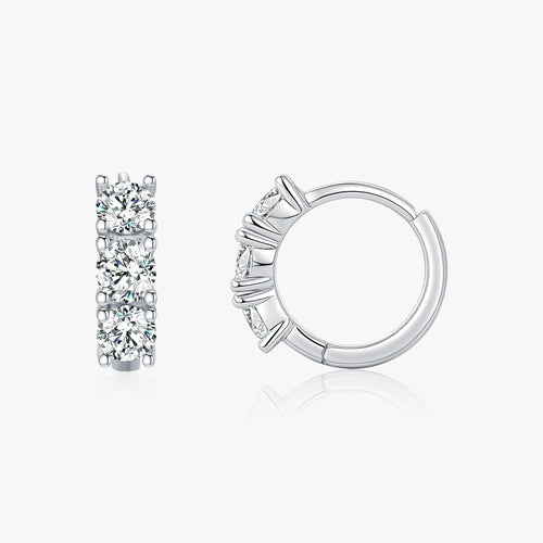 Pair of silver hoop earrings with clear gemstones on a white background