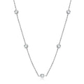 Silver necklace with small round pendants on a white background