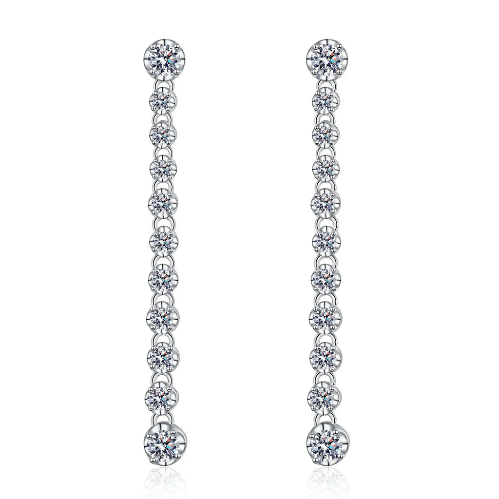 Pair of silver earrings with clear gemstones on a white background