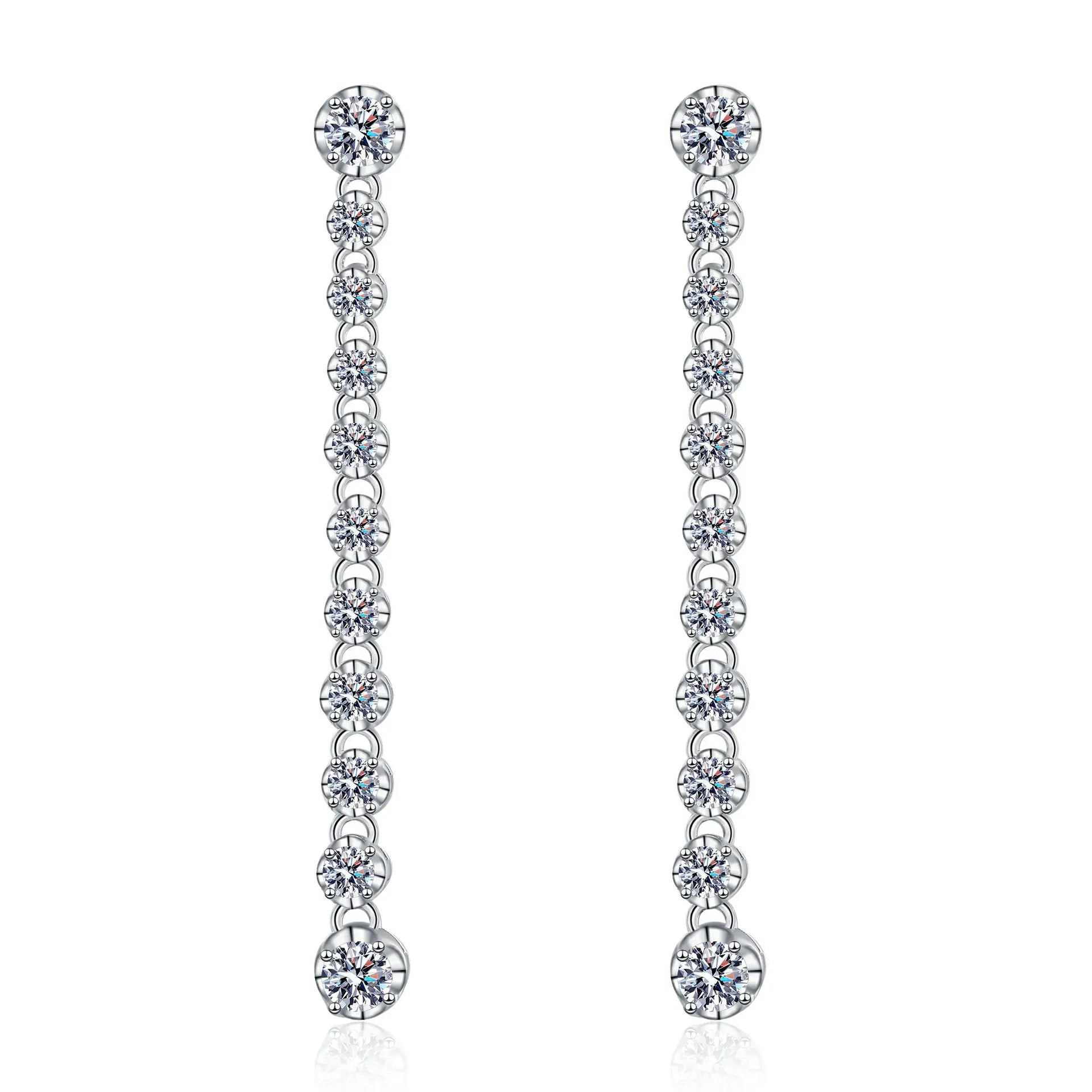 Pair of silver earrings with clear gemstones on a white background