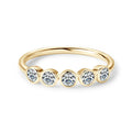 Gold ring with five diamonds on a white background