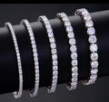 Four Moissanite bracelets on a black surface