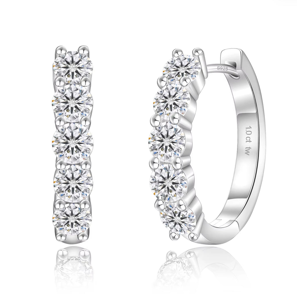 Silver hoop earrings with clear gemstones on a white background