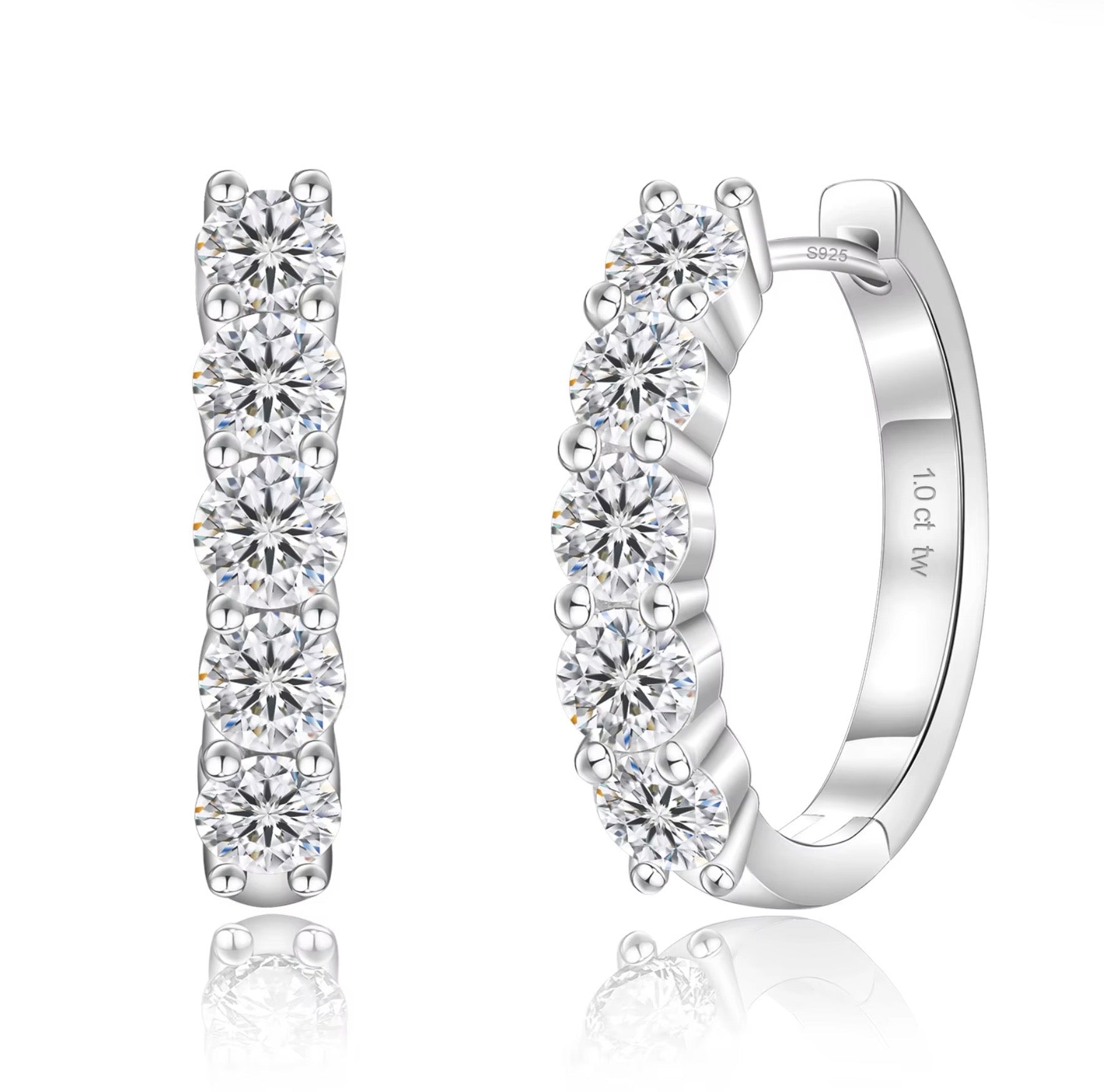 Silver hoop earrings with clear gemstones on a white background